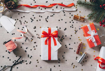 White present with red ribbon bow on decorated festive table