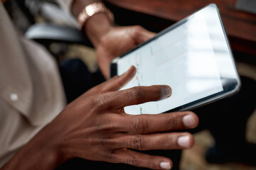 Nurture the future. Close up shot of hands holding tablet pc. Trader is using touch screen tablet for analyzing stock market chart, while working in the office