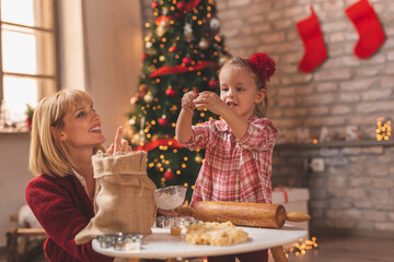 Mother and daughter making gingerbread Christmas cookies