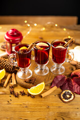 Christmas magic atmosphere, home celebration. Hot mulled wine, spices and festive decorations. Winter holidays celebration concept