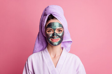 Close-up portrait of attractive cheery housewife wearing towel turban on head clay mask modern lift peel effect isolated over pink color background