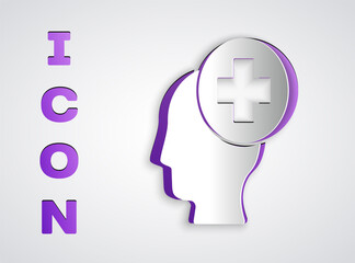 Paper cut Male head with hospital icon isolated on grey background. Head with mental health, healthcare and medical sign. Paper art style. Vector.