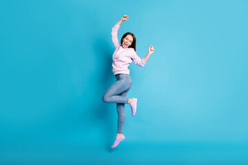Fototapeta premium Full length photo of delighted girl celebrate spring season discount lottery win raise fists scream wear lilac pullover sneakers isolated over blue color background