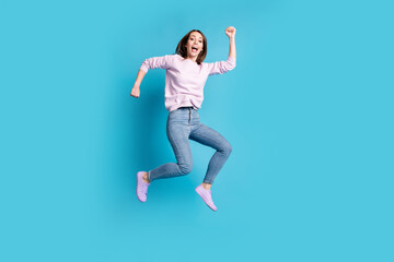 Full length photo of cheerful excited girl jump enjoy spring season discount wear lilac pullover gumshoes isolated over blue color background