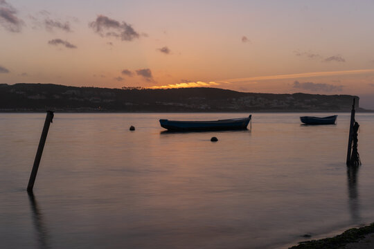 Fishing boats on a river sea at sunset in Foz do Arelho, Portugal © Luis
