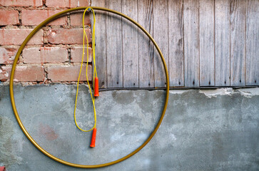 Hoop and skipping rope hanging on wall