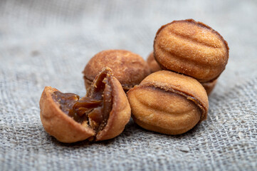 Delicious homemade cookies on the background of rough homespun fabric. Close-up, selective focus.