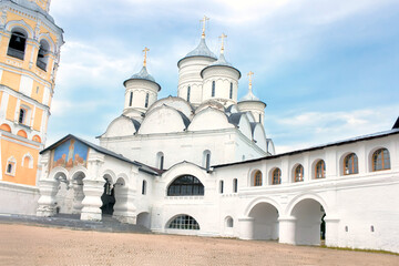 The ancient cathedral against the background of the blue sky.
