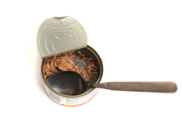 Tuna in an open tin can on a white background. Eat fish from a can.