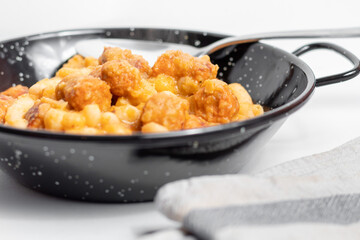 White bean with chorizo ​​in a typical black casserole, typical Asturian food