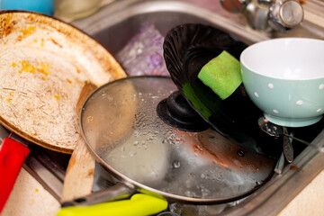 Dirty dishes in the kitchen sink.