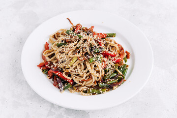 Udon wok with chicken, bell pepper, green onions and sesame seeds