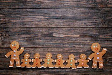 Gingerbread man and cookies numbers 2021 on wooden background. Happy New Year and holidays. Christmas or New Year composition. Christmas card. Holiday background. Copy space.