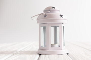 Christmas tree in a pot on white background. Christmas tree decoration. Lantern with candle and lamps on white background. Christmas composition and decoration