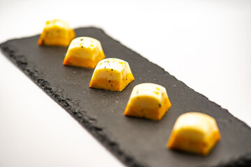 Author's sweets for a holiday, wedding, birthday, anniversary. Yellow candies on a white background in the studio.