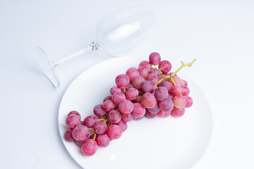 Red grapes on a white background.