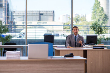 Young male employee working in the office