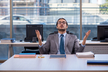 Young male employee working in the office