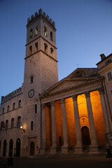Square of the town of Assisi with the tower bell, in the evening