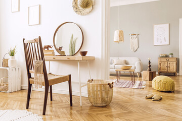 Modern concept in design home interior of open space with wooden desk, coffee table, sofa, chair, plants, mirror, macrame and elegant accessories. Stylish and minimalistic home decor. Template.