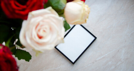 Greeting, post card, photo frame mock up on marble background with the bouquet of roses