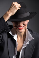 Portrait of a beautiful woman in a hat and boyfriend oversize huge suit. retro woman