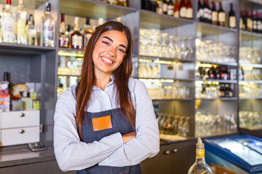 Waitress wearing apron smilling looking at camera. Happy businesswoman. Small business owner of girl entrepreneur. Cafe employee posing in restaurant coffee shop