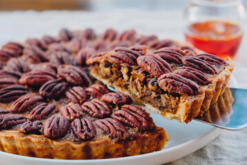 Delicious freshly baked homemade pecan pie, close up. Popular holiday meal for Thanksgiving and...