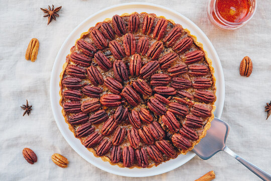 Delicious Freshly Baked Homemade Pecan Pie On White Tablecloth. Sweet Food From Above. Popular Holiday Meal For Thanksgiving And Christmas.