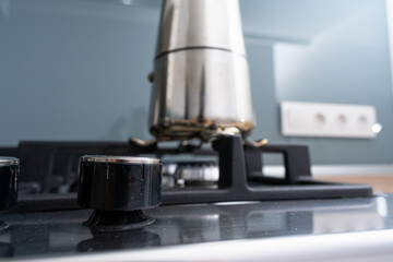 Italian metallic coffee maker. Mocha coffee pot for making espresso coffee. Coffee maker on gas stove