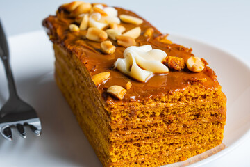 Tasty chocolate cake on white plate. Piece of cake on a plate isolated on white.