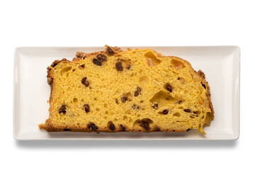 Slice of panettone on rectangular white plate in top view, typical Italian dessert for Christmas from Milan, isolated on white background
