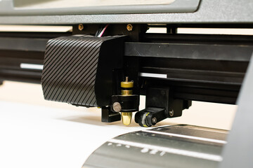 Cutting plotter close-up. The process of cutting a vinyl film. Vinyl cutting. Cutting machine stickers.