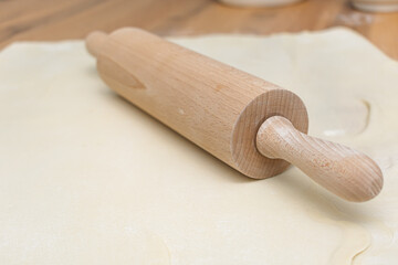 Close up wooden rolling pin on wooden table top view