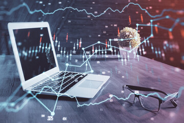 Financial graph colorful drawing and table with computer on background. Double exposure. Concept of...