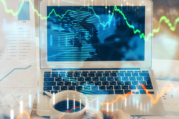Forex Chart hologram on table with computer background. Double exposure. Concept of financial markets.