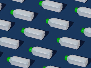 Large bottles with hand sanitizer lying on a blue background pattern. Prevention of Covid-19 virus.