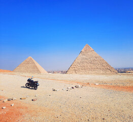 Motorcycle stands in front of the pyramids in Cairo