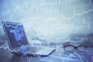 Forex Chart hologram on table with computer background. Multi exposure. Concept of financial markets.