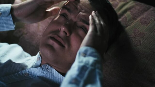 Flood. a man waking up from water dripping from the ceiling, closeup