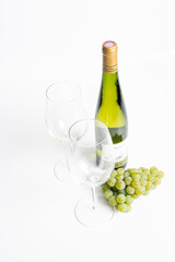 Wine bottle and two wine glasses. Wine bottle against a white background