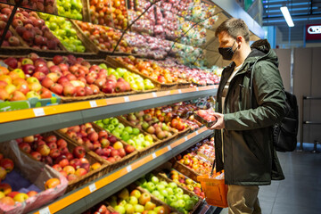 man buying fruits at groceries store