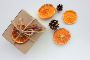 Craft Christmas gift box decorated with dried orange and cinnamon sticks. Zero waste echo-friendly present. Top view, copy space