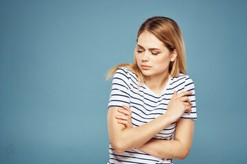 Emotional woman striped t-shirt lifestyle cropped blue background 