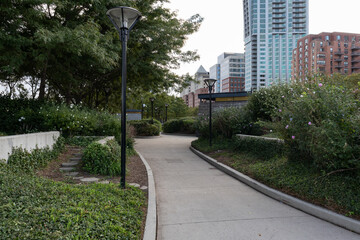 Fototapeta na wymiar Empty Trail at a Park on the Hoboken New Jersey Riverfront with Skyscrapers and Green Trees