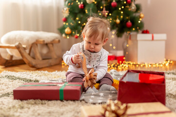 Fototapeta na wymiar Little boy opening Christmas presents