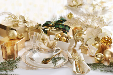 Christmas table setting in white and gold colors in glamour style