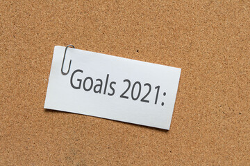 goal 2021 Top view flat lay of desktop and notepads writing down goals and plans. 2021 New Year's goal, plan,action text on notepad with office accessories. Business motivation, inspiration concept.