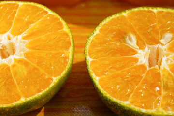 Nature orange cut in half closed up image put on the table with sunlight