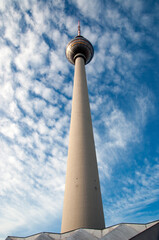 Obraz premium Concrete TV tower. Blue sky and white clouds.